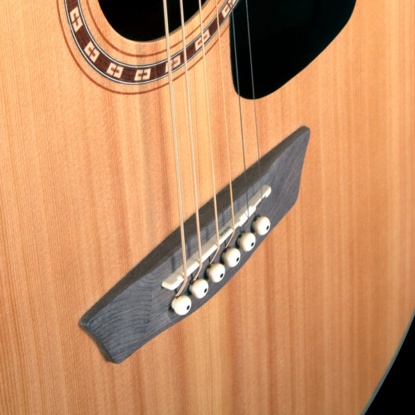 closeup of bridge on acoustic guitar