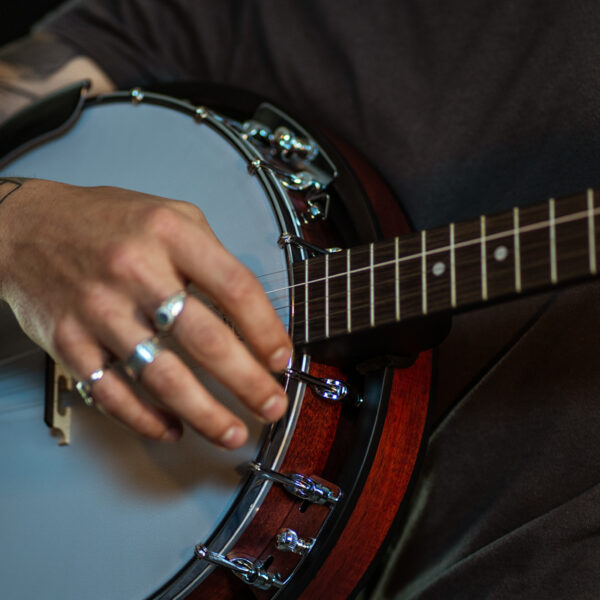 hand of man playing banjo