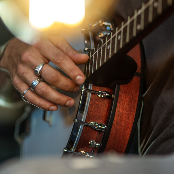 hand of man playing banjo