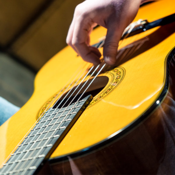 hand strumming Washburn classical guitar