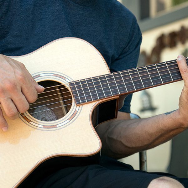 man playing washburn guitar