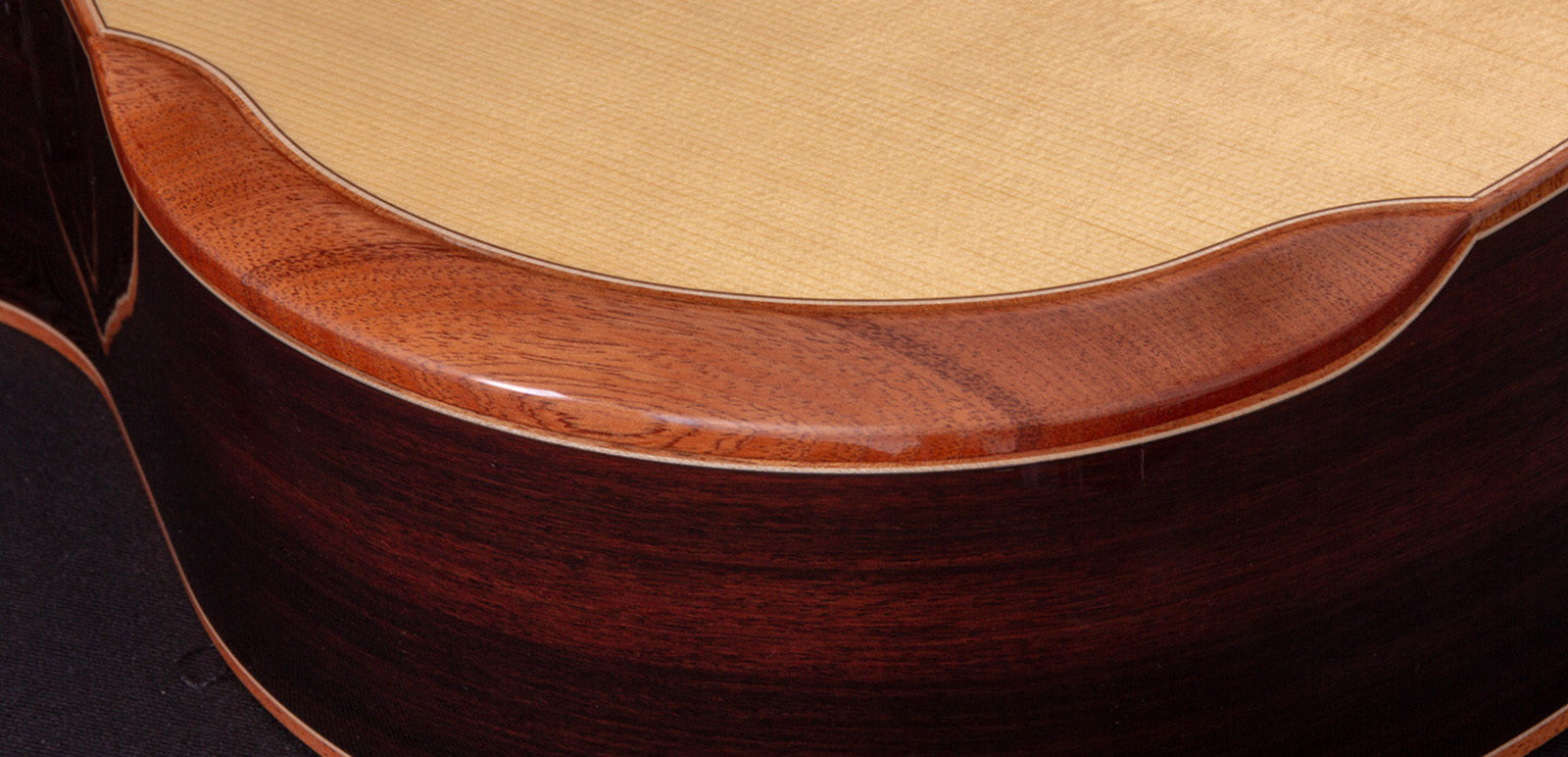 CLOSE UP OF THE COMFORT BEVEL CUT ON COMFORT SERIES GUITARS