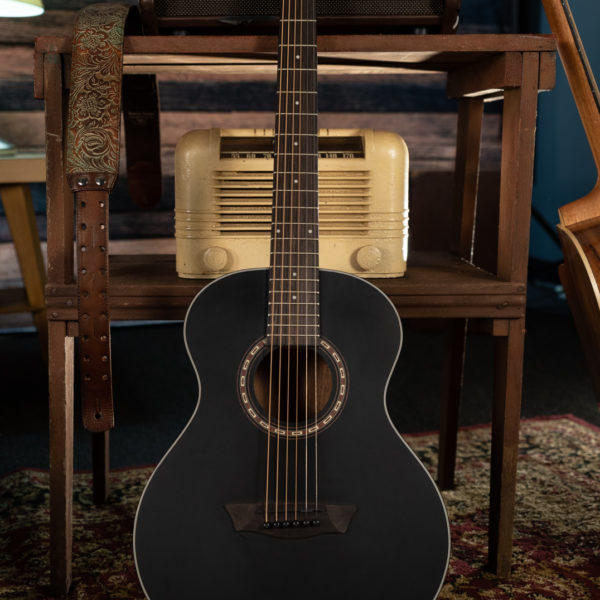 AGM5BMK Apprentice G Mini guitar leaning against table with vintage radio