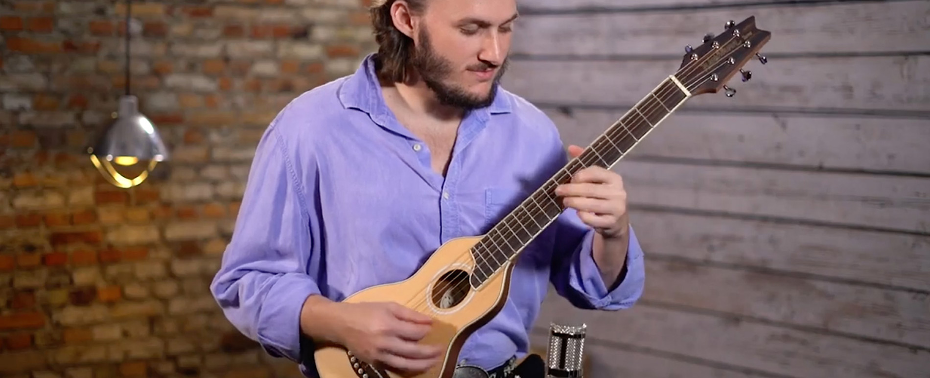 Artist playing Rover Travel Acoustic guitar