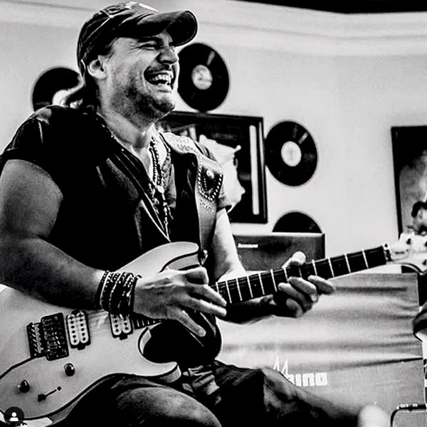 black and white image of musician playing Washburn electric guitar