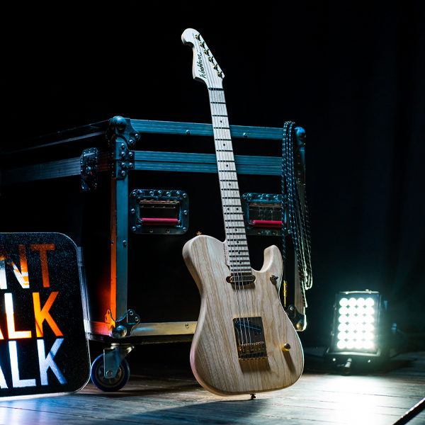 Washburn electric guitar beside Don't Walk sign on stage