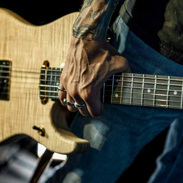 man's HAND HOLDING Washburn electric guitar